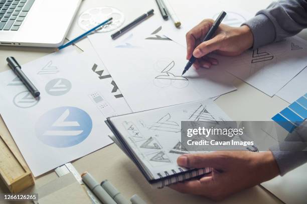 graphic designer drawing sketch design creative ideas draft logo - intellectueel eigendom stockfoto's en -beelden