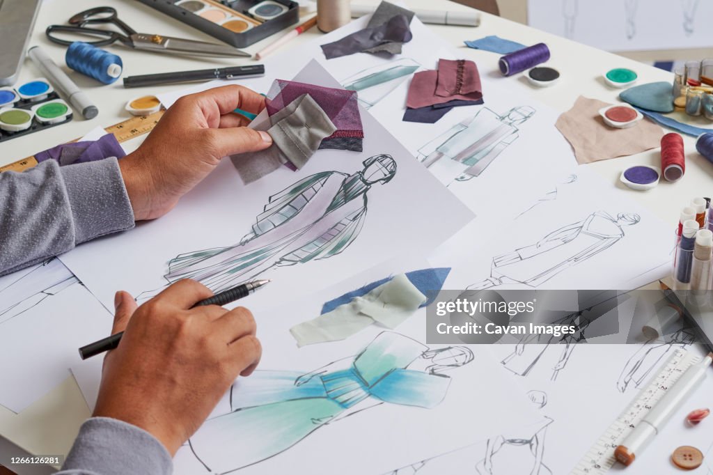 Fashion designer sketching costume design