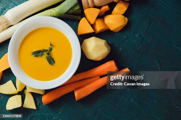 freshly made pumpkin pur√©e with its ingredients on a green background - seville food stock pictures, royalty-free photos & images