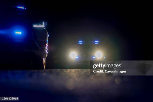 police cars at night during confinement - terrorism city stock pictures, royalty-free photos & images