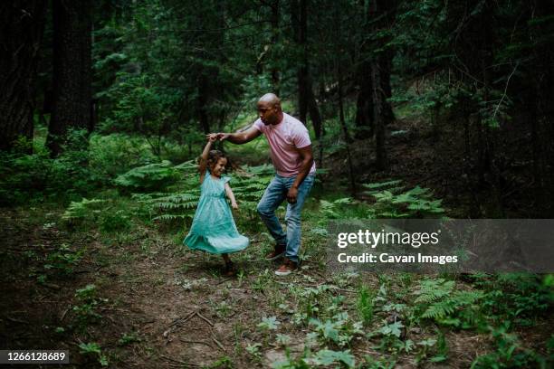 father and daughter dancing in the middle of the forest - father daughter dance stock-fotos und bilder