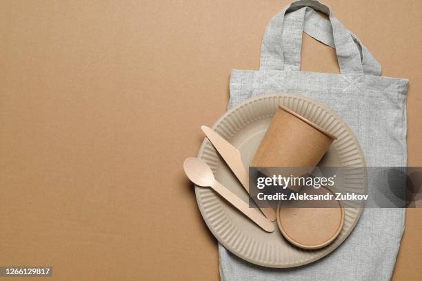 disposable eco-friendly tableware, reusable bag-string bag on a cardboard background. secondary use. no plastic. shopping bag made of recycled materials. - plastic free stock pictures, royalty-free photos & images