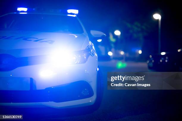 police car with emergency lights on - police siren stock pictures, royalty-free photos & images