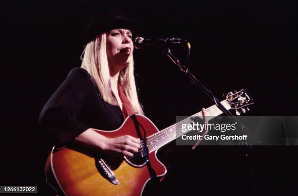American Pop, Rock, and R&B musician Rickie Lee Jones plays acoustic guitar as she performs onstage at the Ritz, New York, New York, March 27, 1983.