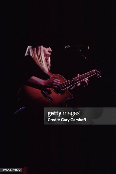 American Pop, Rock, and R&B musician Rickie Lee Jones plays acoustic guitar as she performs onstage at the Ritz, New York, New York, March 27, 1983.