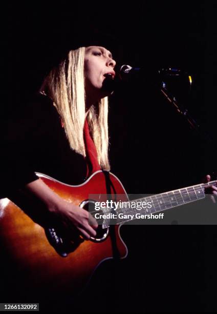 American Pop, Rock, and R&B musician Rickie Lee Jones plays acoustic guitar as she performs onstage at the Ritz, New York, New York, March 27, 1983.