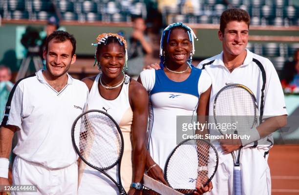 Venus Williams and Justin Gimelstob of United States and Serena Williams of the United States and Luis Lobo of Argentina pose before the start of...