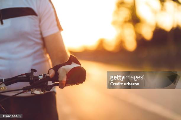 cyclist holding bicycle steering wheel - triathlon gear stock pictures, royalty-free photos & images