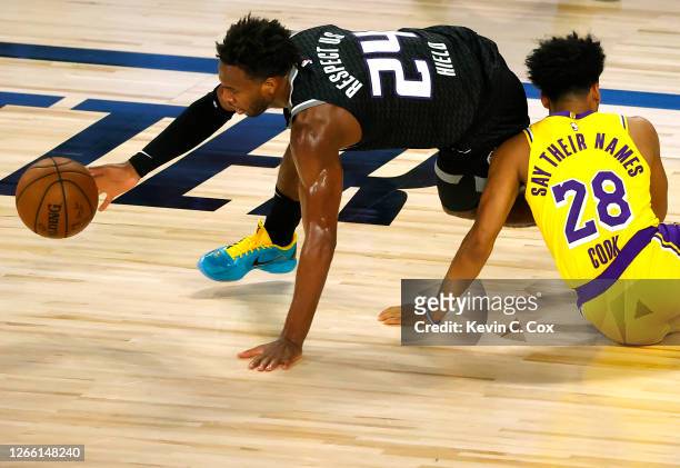Buddy Hield of the Sacramento Kings grabs the ball after colliding with Quinn Cook of the Los Angeles Lakers during the second quarter at The Field...