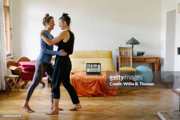 couple practicing dancing the tango at home together - tango stockfoto's en -beelden