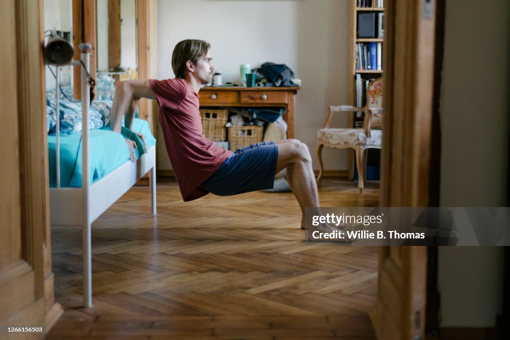 Young Man Doing Body Weight Exercises At Home