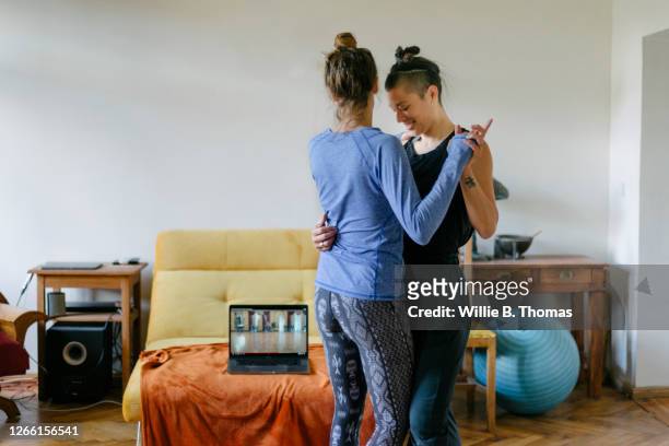 couple learning the tango at home together - lesbians stock-fotos und bilder