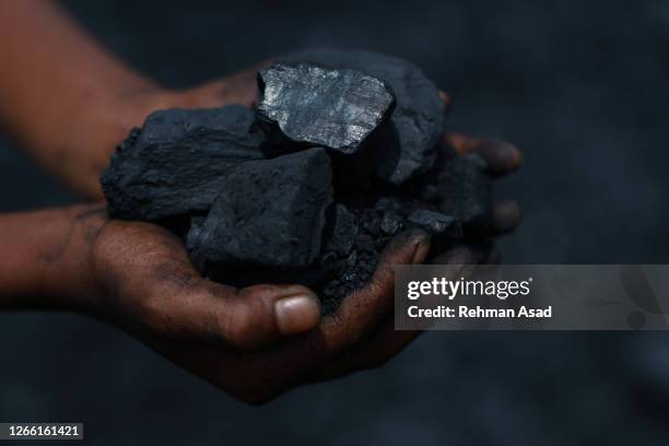 holding a handful of coal - miner stock pictures, royalty-free photos & images