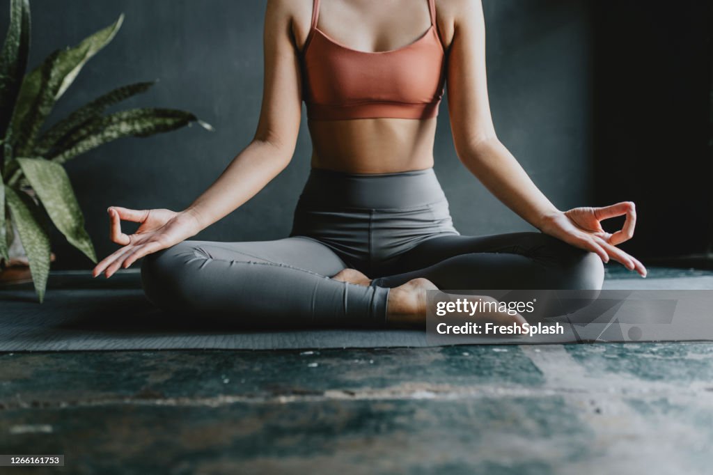 Anonymous Woman Doing Yoga at Home: Lotus Position