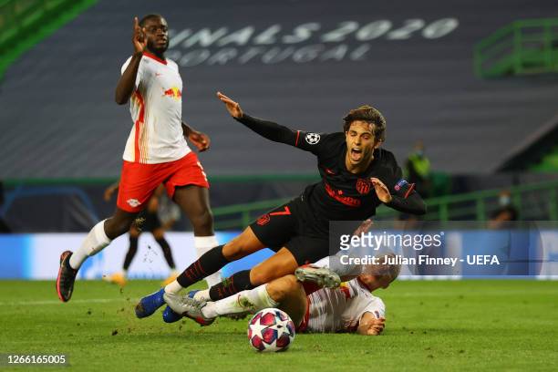 Joao Felix of Atletico de Madrid is fouled by Lukas Klostermann of RB Leipzig inside the penalty area leading to Atletico de Madrid being awarded a...