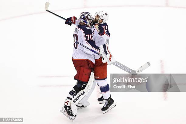 Joonas Korpisalo and Nick Foligno of the Columbus Blue Jackets celebrate their teams 3-1 win against the Tampa Bay Lightning in Game Two of the...