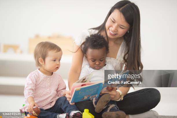 storytime at daycare - nanny stock pictures, royalty-free photos & images