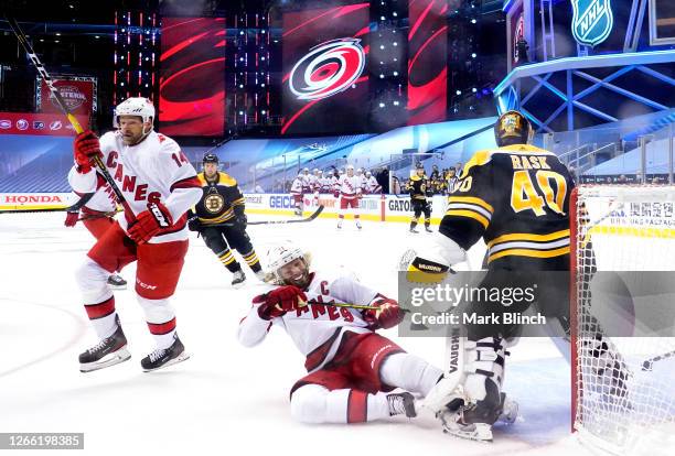 Jordan Staal of the Carolina Hurricanes collides goaltender Tuukka Rask of the Boston Bruins next to Justin Williams during the first period of Game...