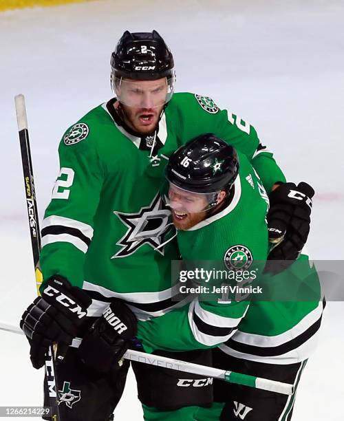 Jamie Oleksiak of the Dallas Stars celebrates his game winning goal at 19:20 of the third period against the Calgary Flames and is joined by Joe...