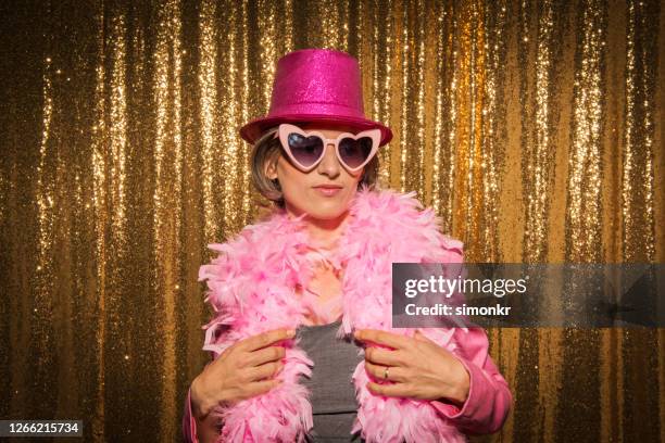 mature woman enjoying party - feather boa stock pictures, royalty-free photos & images
