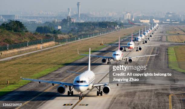 a large number of aircraft sliding in a line for take off in chengdu shuangliu international airport，sichuan，china - crowded airplane stock pictures, royalty-free photos & images