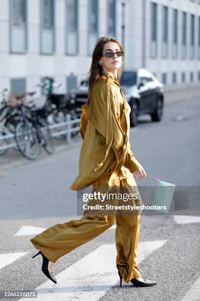 Influencer Sarah Lou Falk, wearing a golden suit by Lala Berlin, heels by Custommade, a mint colored bag by Louis Vuitton and sunglasses by Gucci...