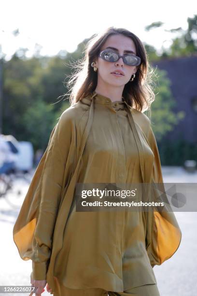 Influencer Sarah Lou Falk, wearing a golden suit by Lala Berlin and sunglasses by Gucci during a street style shooting at Copenhagen Fashion Week...