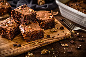 Homemade chocolate brownie on a rustic wooden table