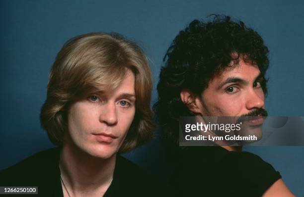 American rock and soul duo Hall & Oates in a studio portrait, against a blue background, circa 1980.