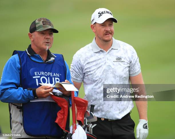 Jacques Kruyswijk of South Africa and caddie Kyle Roadley ponder his approach shot on the fourth hole during day two of the Celtic Classic at the...