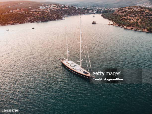 bird’s eye-view of a seaside town at sunset - luxury yacht stock pictures, royalty-free photos & images