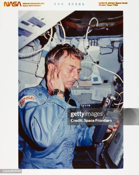 Mission specialist Owen K Garriott uses a ham radio on the Space Shuttle Columbia to contact radio operators on Earth, during NASA's STS-9 mission,...