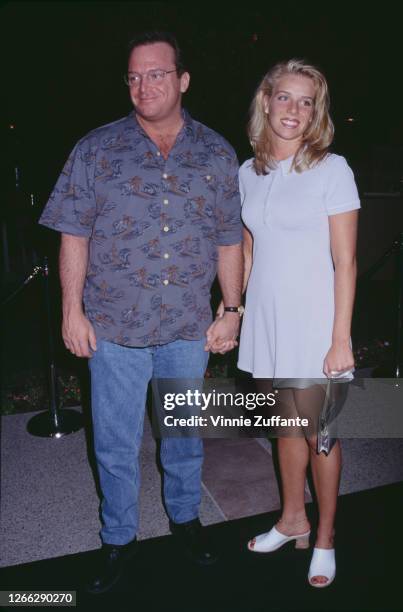 American actor and comedian Tom Arnold and his wife Julie at the premiere of the film 'Tommy Boy' in Hollywood, California, 29th March 1995.