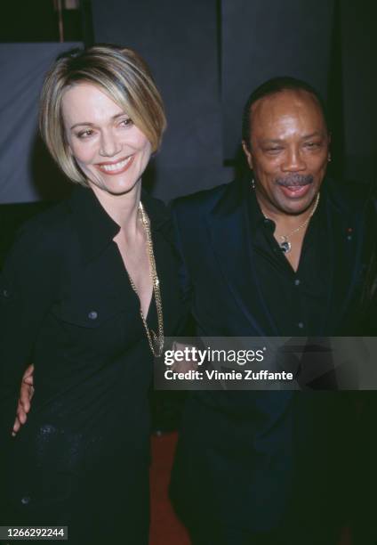 American record producer Quincy Jones with actress and model Peggy Lipton at the 1996 Fire and Ice Ball at the Warner Brothers Studios in Hollywood,...