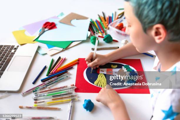 child doing creative hand made work with color paper and plasticine. kids crafts. - art manke stock pictures, royalty-free photos & images