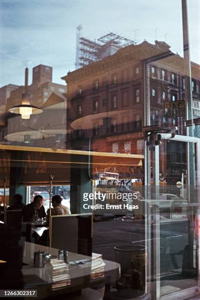 Street scene reflected in the windows of a diner in New York City, 1962.