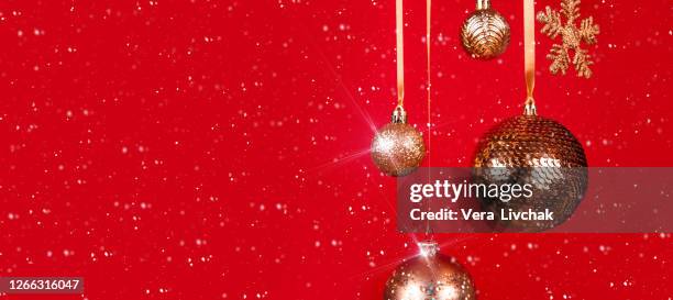new year 2021 banner. holyday concept. many golden christmas baubles hanging against the red background. selective focus. copy space. - three year stock pictures, royalty-free photos & images