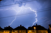Lightning Storm in Night Sky Above Houses