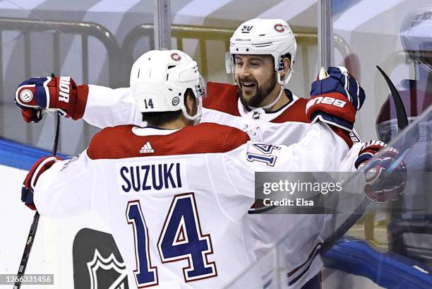 Tomas Tatar of the Montreal Canadiens celebrates with Nick Suzuki after scoring a goal on Carter Hart of the Philadelphia Flyers during the first...