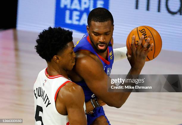 Noah Vonleh of the Denver Nuggets drives the ball against Stanley Johnson of the Toronto Raptors during the fourth quarter at The Field House at ESPN...