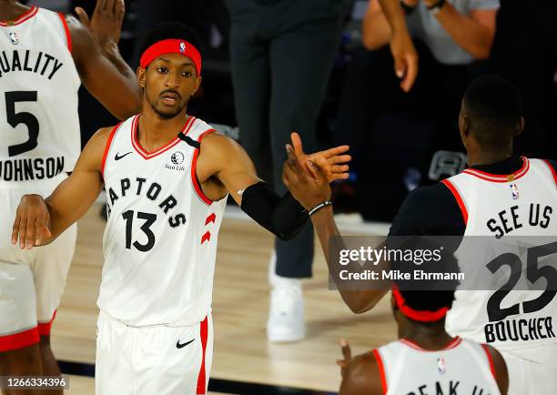 Malcolm Miller of the Toronto Raptors and Chris Boucher of the Toronto Raptors congratulate each other after a point during the fourth quarter...