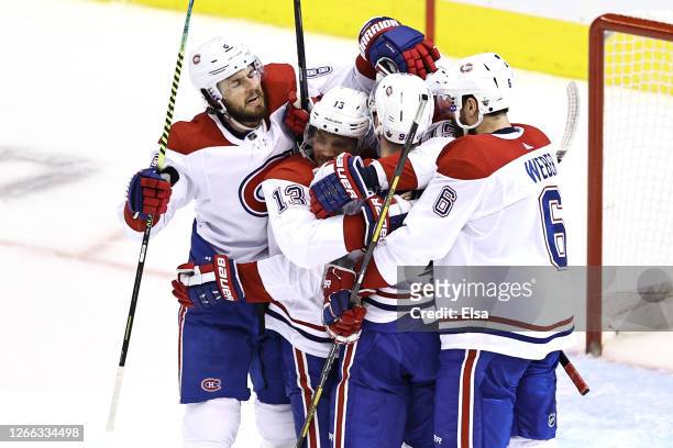 Jesperi Kotkaniemi of the Montreal Canadiens celebrates with his teammates after scoring a goal on Carter Hart of the Philadelphia Flyers during the...