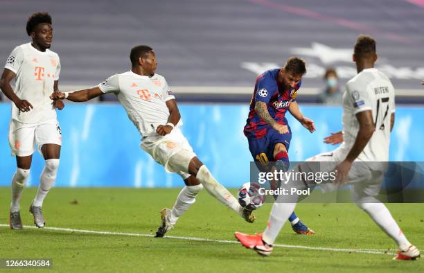 Lionel Messi of FC Barcelona shoots past David Alaba of FC Bayern Munich during the UEFA Champions League Quarter Final match between Barcelona and...