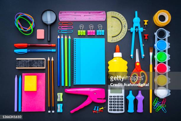 multicolored school supplies shot from above on black background. - knolling tools stock pictures, royalty-free photos & images