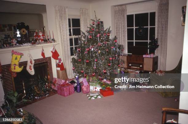 Christmas tree packed with presents awaits children on Christmas morning, 1973.