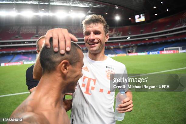 Thomas Mueller of FC Bayern Munich and Thiago of FC Bayern Munich celebrate following their team's victory in the UEFA Champions League Quarter Final...