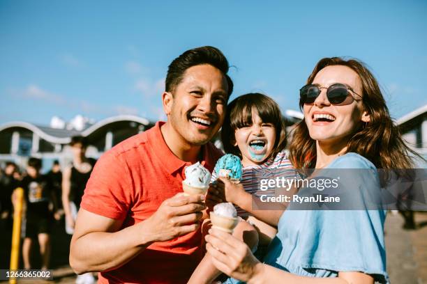 family eating ice cream at california pier - girl eating messy ice cream cone stock pictures, royalty-free photos & images