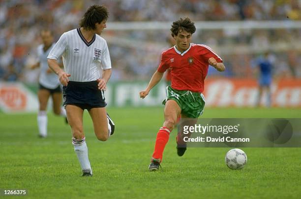 Paulo Futre of Portugal takes on Terry Fenwick of England during the World Cup match at the Technologico Stadium in Monterrey, Mexico. Portugal won...