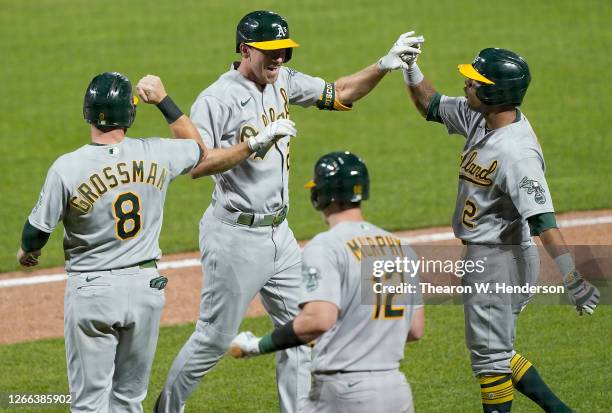 Stephen Piscotty, Khris Davis, Sean Murphy and Robbie Grossman of the Oakland Athletics celebrate after Piscotty hit a game-tying grand slam against...