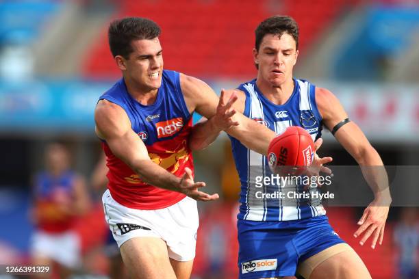 Brandon Starcevich of the Lions and Luke Davies-Uniacke of the Kangaroos compete for the ball during the round 12 AFL match between the North...